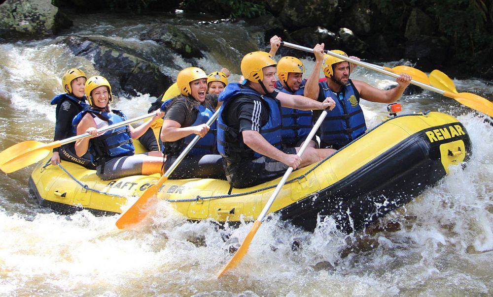 A group of happy people white-water rafting